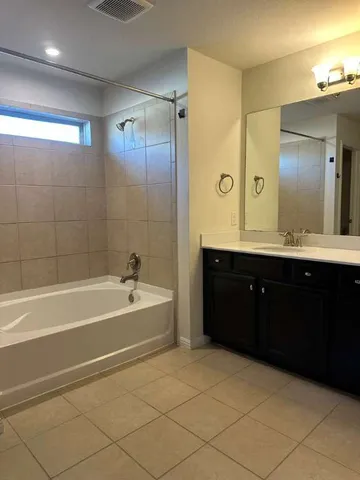 a kitchen with kitchen island granite countertop stainless steel appliances and wooden cabinets
