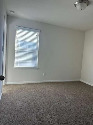 a large kitchen with kitchen island granite countertop wooden cabinets a refrigerator a sink and dishwasher