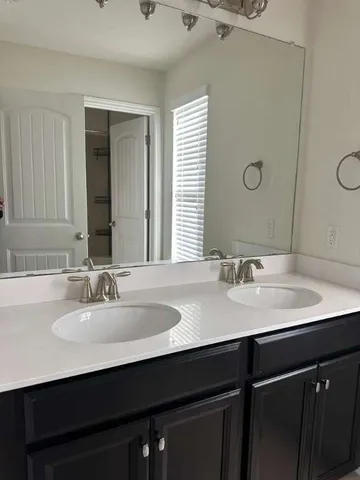 a spacious bathroom with a bathtub sink and mirror