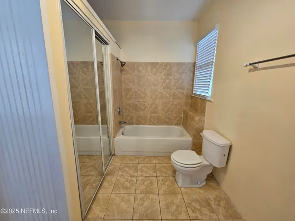 a bathroom with a toilet and a bathtub