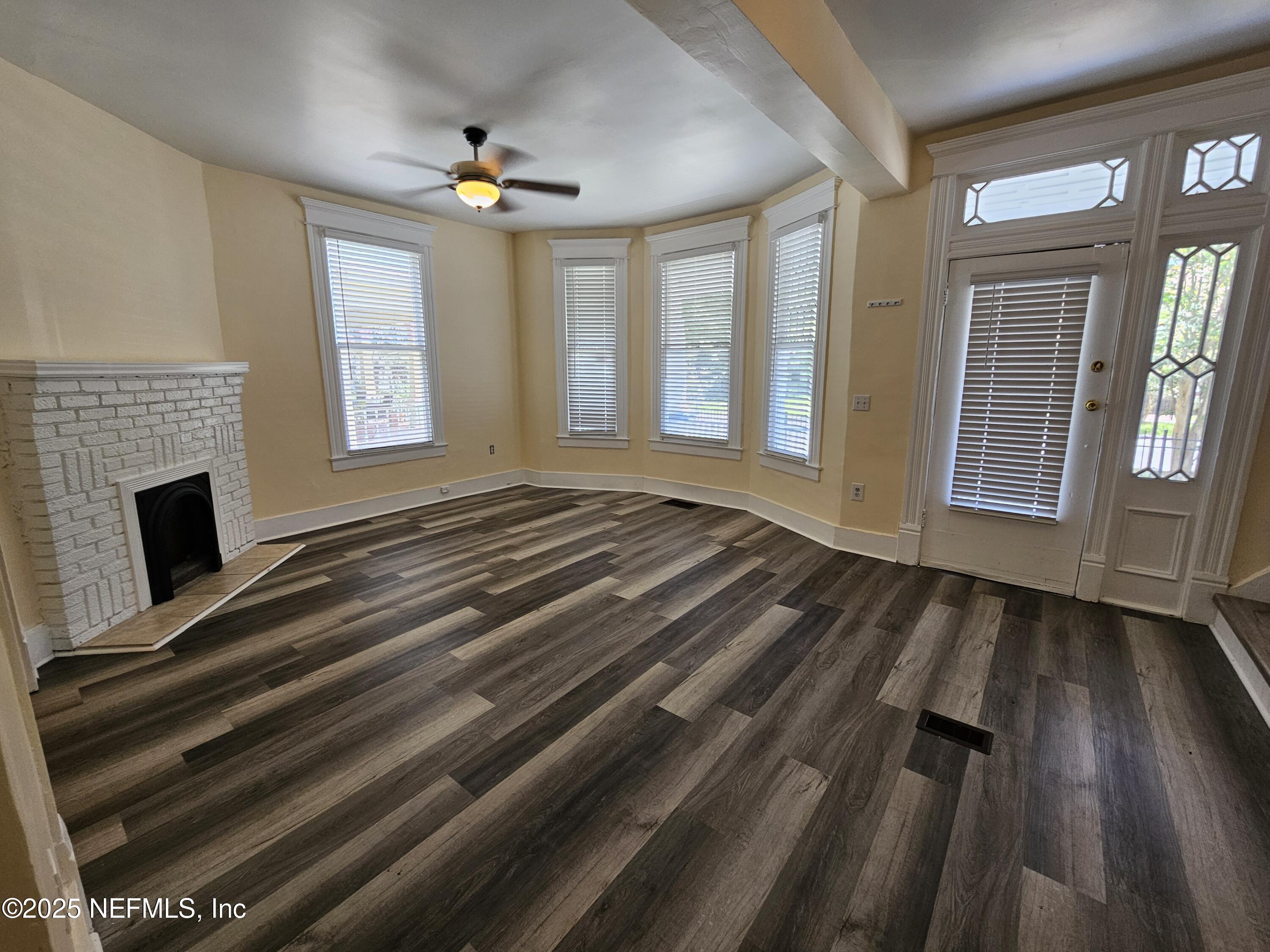 307 East 9th Street Jacksonville, FL 32206 - Photo 2 of 17 a view of an empty room with wooden floor and a window