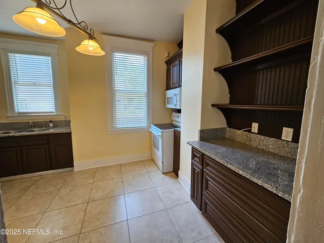 a kitchen with a stove and a cabinets