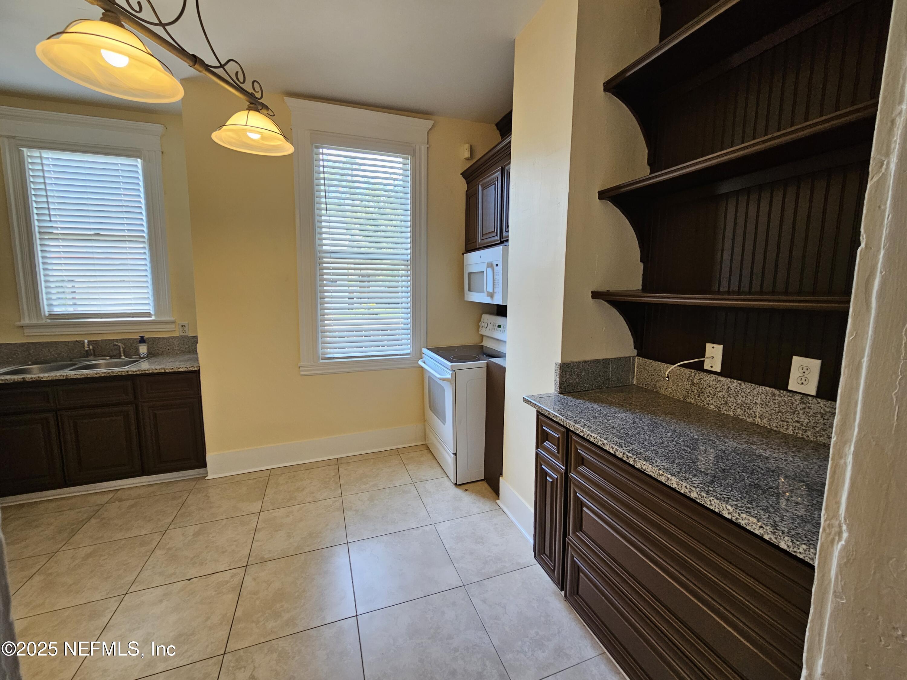 307 East 9th Street Jacksonville, FL 32206 - Photo 4 of 17 a kitchen with a stove and a cabinets