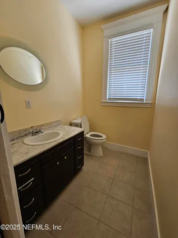 a bathroom with a sink vanity and a toilet