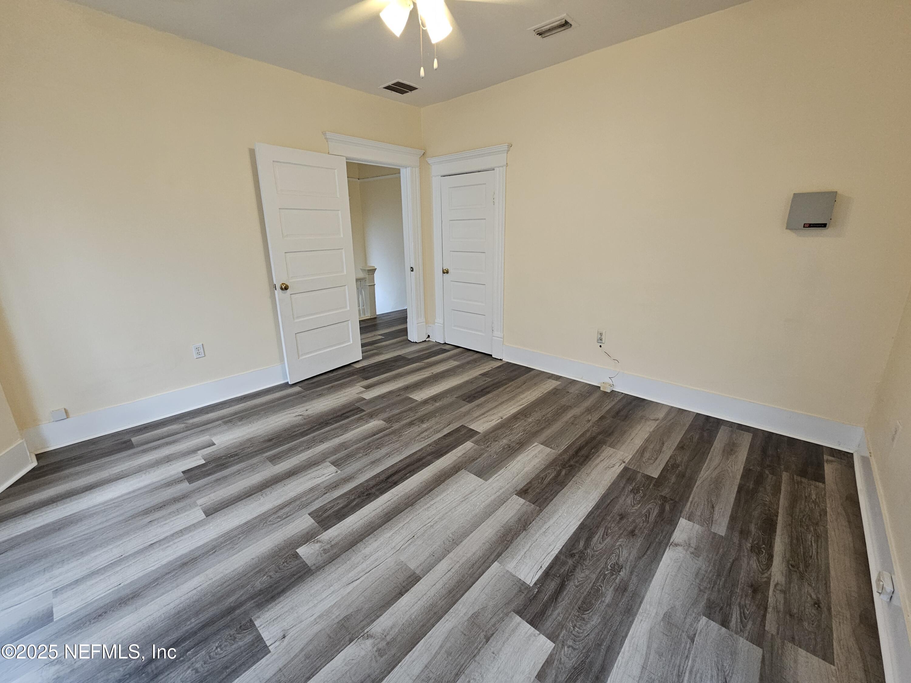 307 East 9th Street Jacksonville, FL 32206 - Photo 10 of 17 a view of a room with wooden floor and ceiling fan