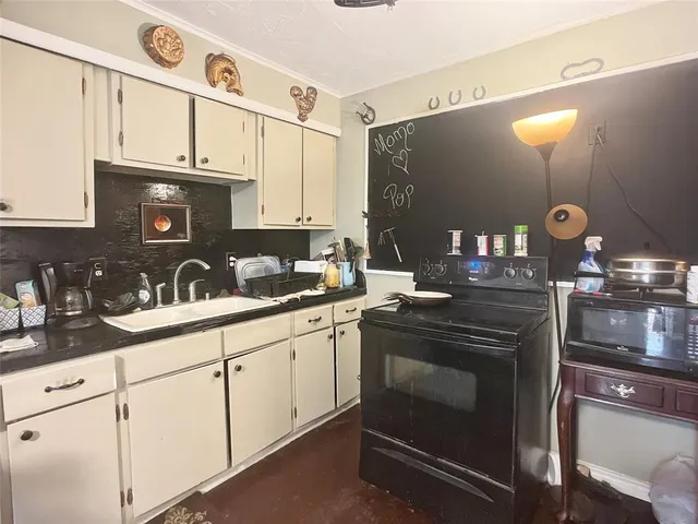 a kitchen with a sink appliances and cabinets