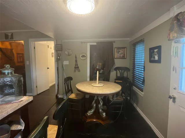 a view of a dining room with furniture and window