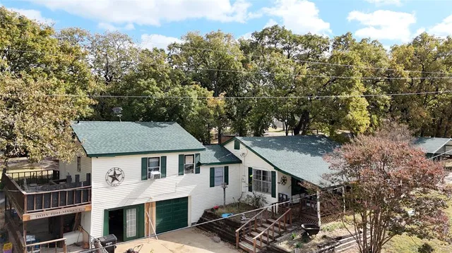 an aerial view of a house with a yard
