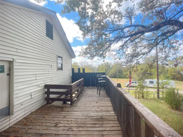 a view of a yard with wooden fence