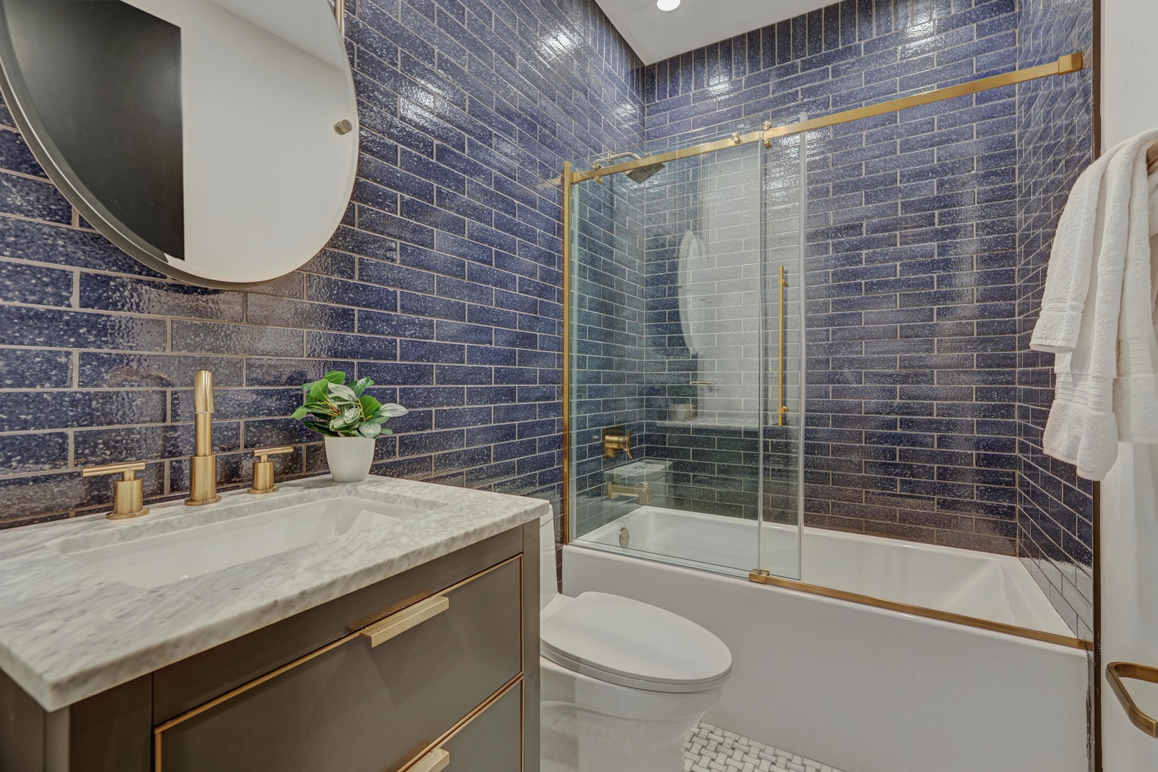 3406 North Keating Avenue Chicago, IL 60641 - Photo 24 of 30 a bathroom with a granite countertop toilet a sink and bathtub