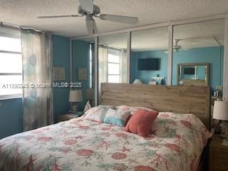 345 Ocean Drive, Unit 714 Miami Beach, FL 33139 - Photo 10 of 32 a bedroom with a large bed and a glass door shower