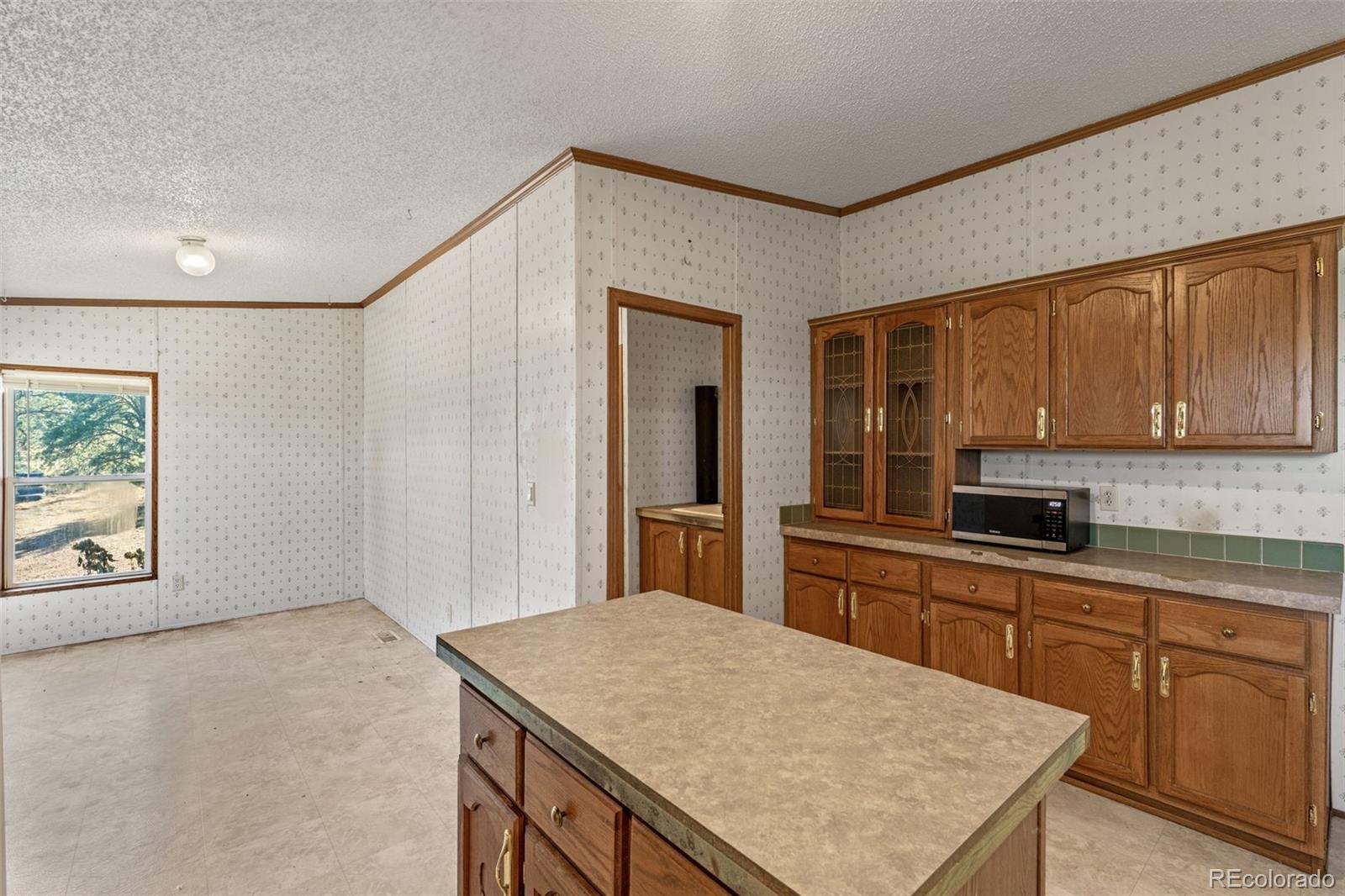 1711 Witcher Mtn. Road Guffey, CO 80820 - Photo 13 of 41 a kitchen with a stove a sink and a refrigerator