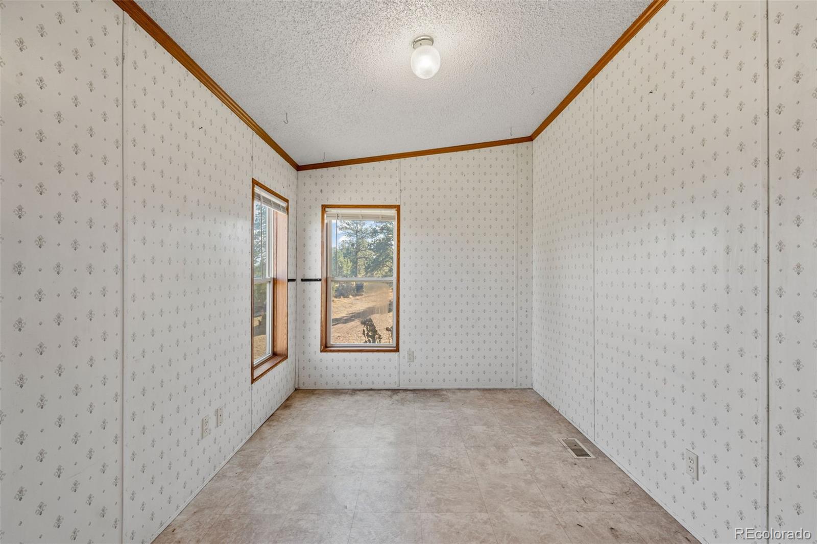 1711 Witcher Mtn. Road Guffey, CO 80820 - Photo 14 of 41 a view of an empty room with a window
