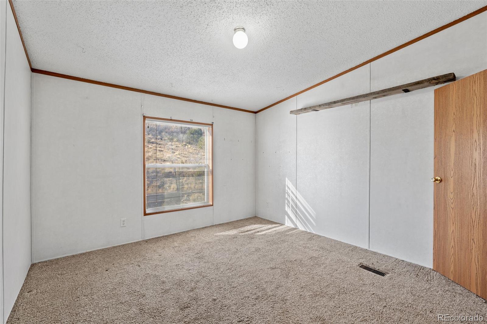 1711 Witcher Mtn. Road Guffey, CO 80820 - Photo 24 of 41 an empty room with a empty space and window