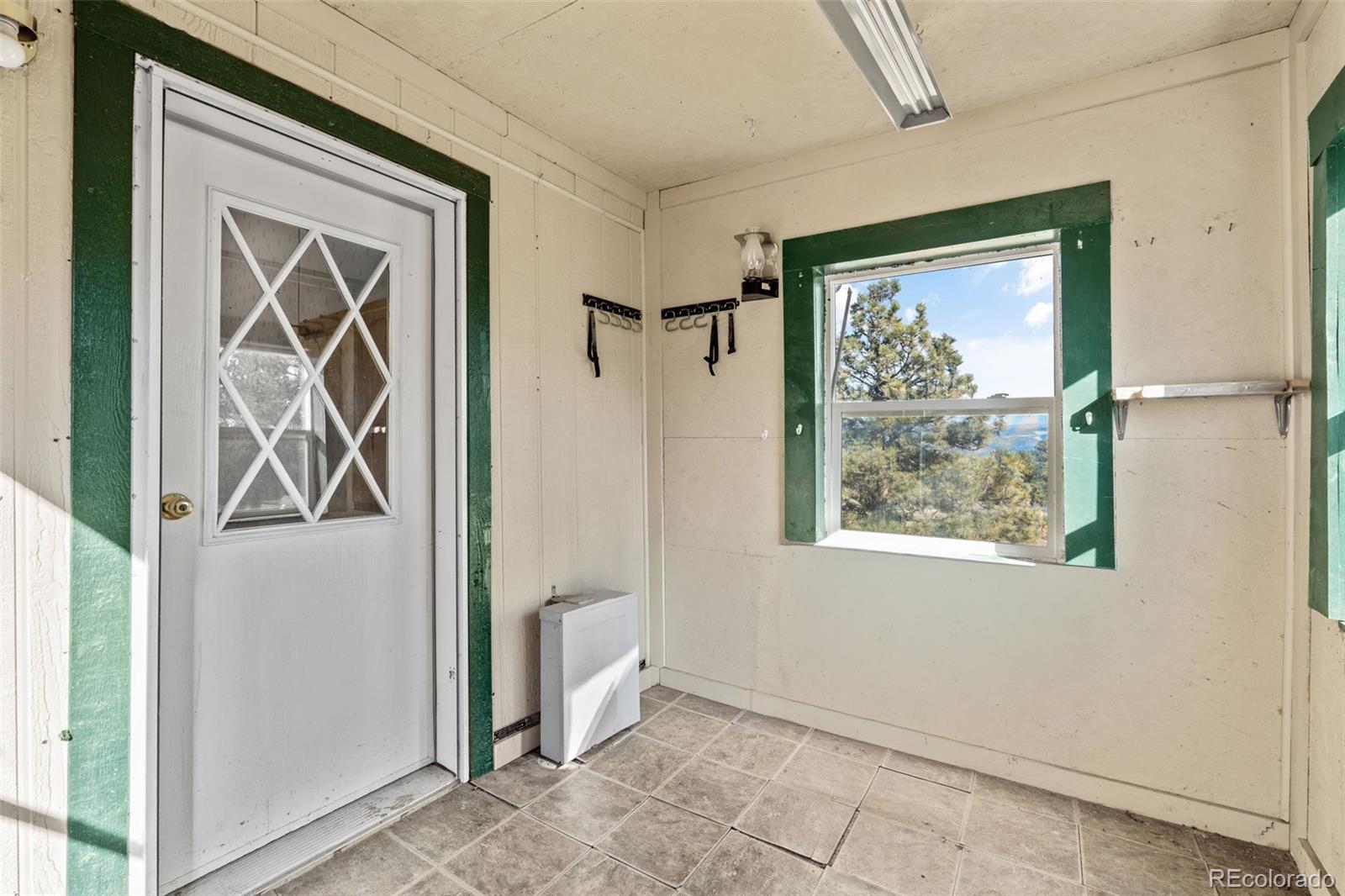 1711 Witcher Mtn. Road Guffey, CO 80820 - Photo 30 of 41 an entryway with wooden floor a mirror