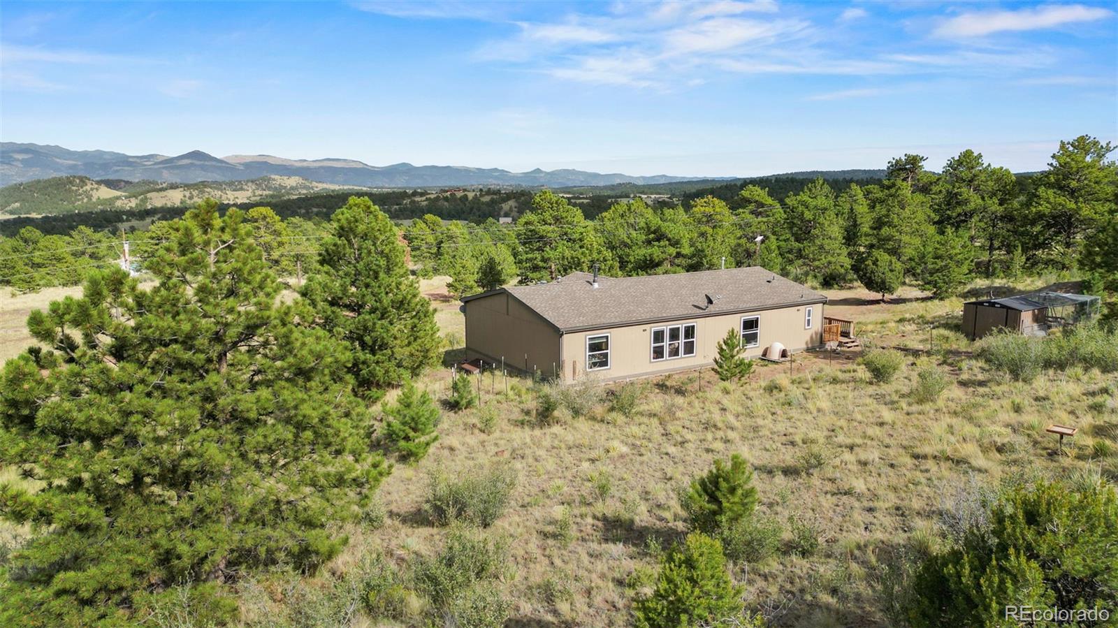 1711 Witcher Mtn. Road Guffey, CO 80820 - Photo 33 of 41 a view of a house with a mountain