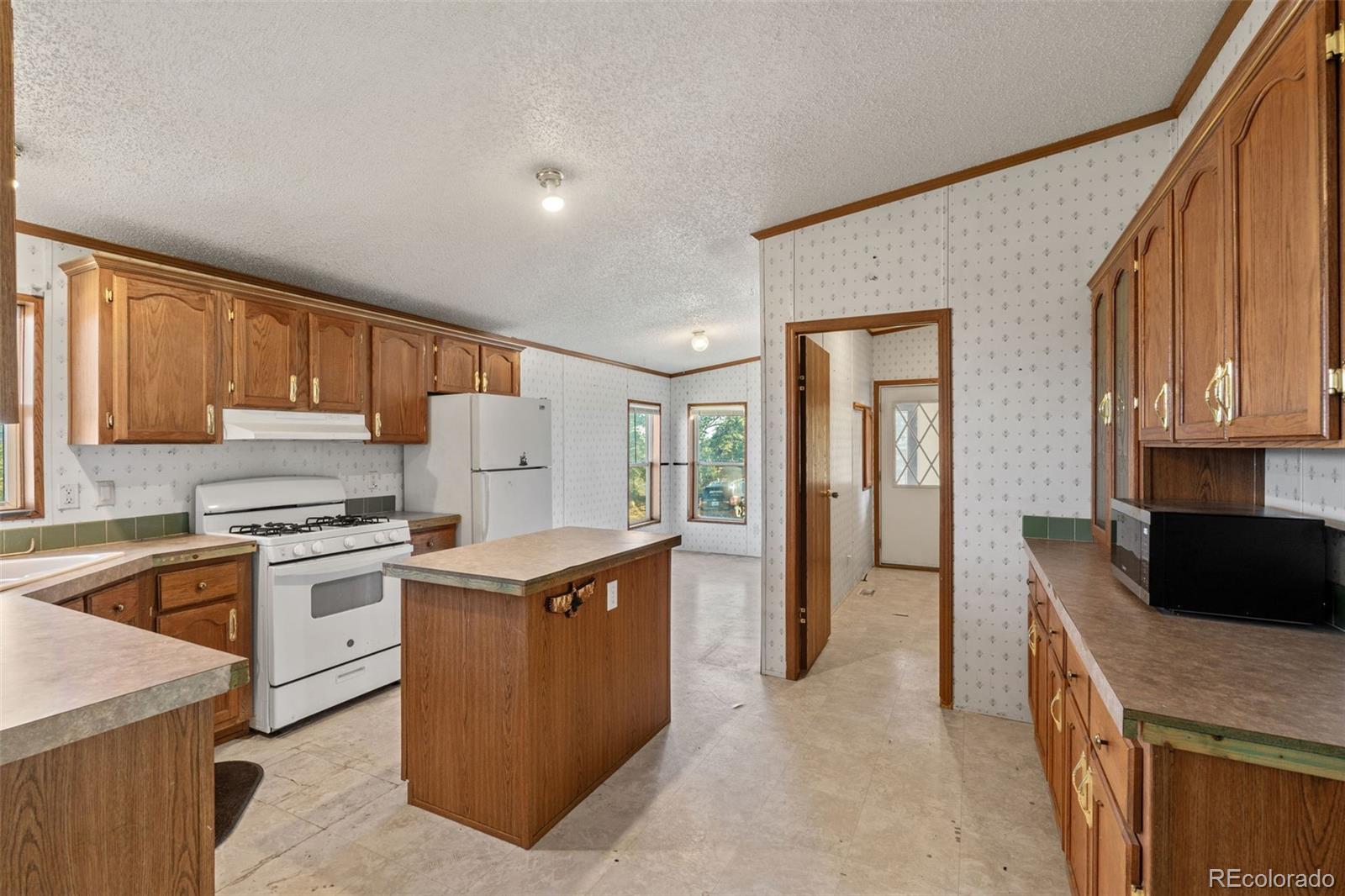 1711 Witcher Mtn. Road Guffey, CO 80820 - Photo 10 of 41 a kitchen with a stove top oven sink and cabinets