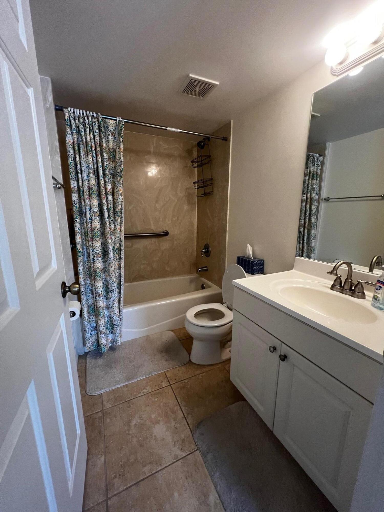 11195 Roseland Road, Unit 5 Sebastian, FL 32958 - Photo 10 of 10 a bathroom with a double vanity sink toilet and shower