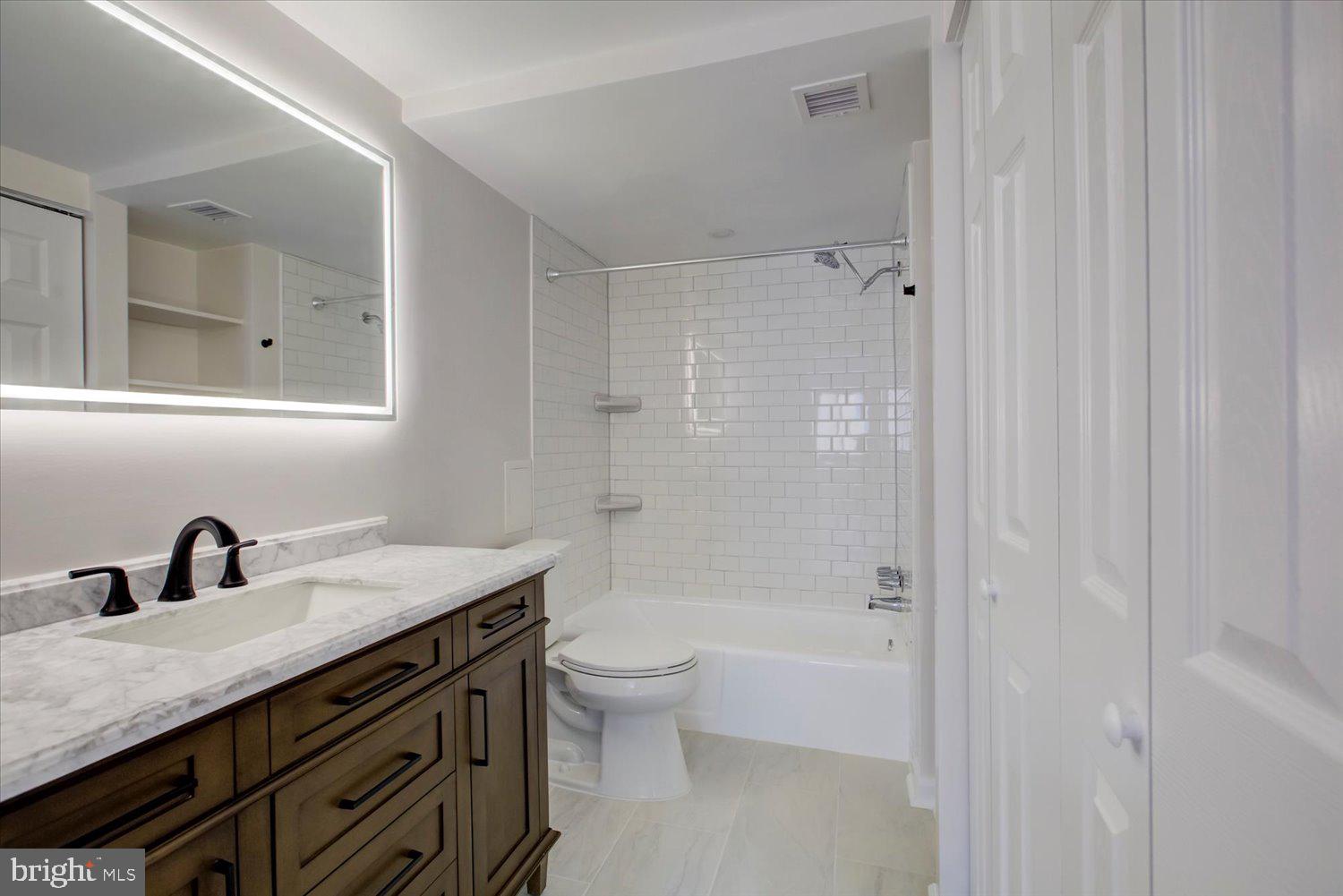 1718 P Street Northwest, Unit 411 Washington, DC 20036 - Photo 13 of 24 a bathroom with a double vanity sink toilet and shower