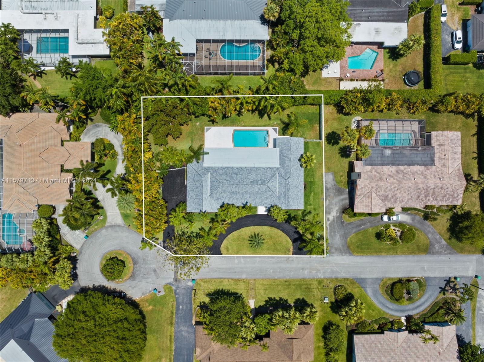 an aerial view of a house a yard and a fountain