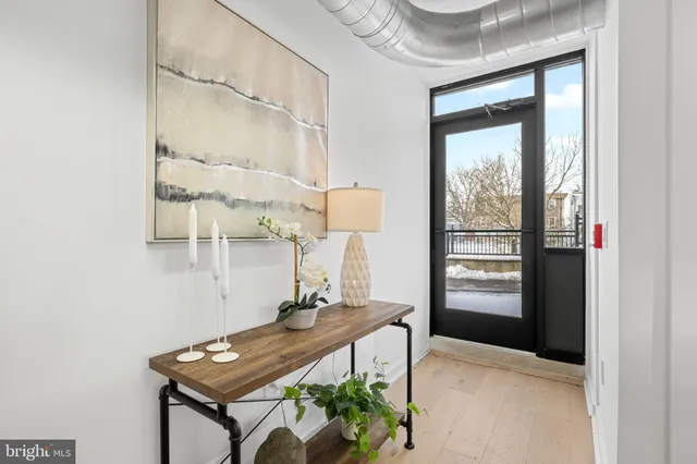 a living room with furniture kitchen and a window