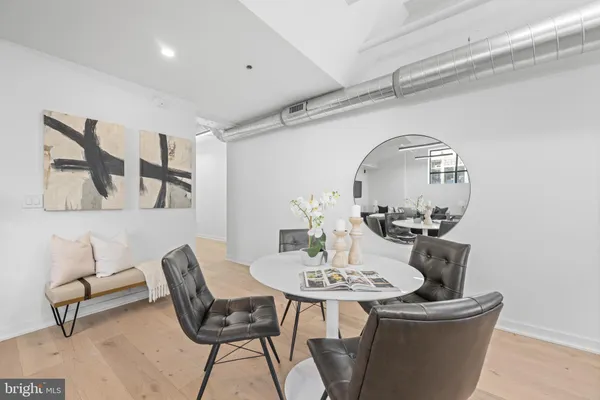 a view of a dining room with furniture and wooden floor