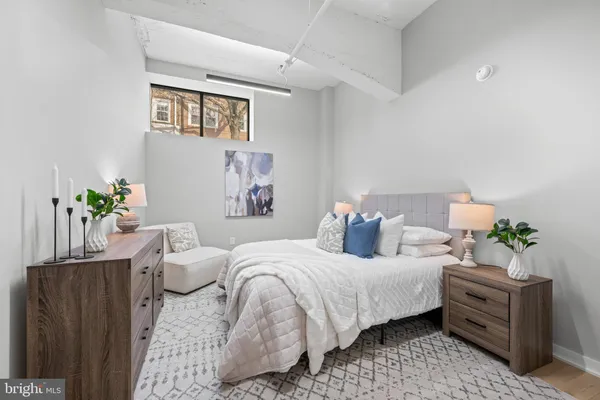 a bedroom with a bed potted plant and a window