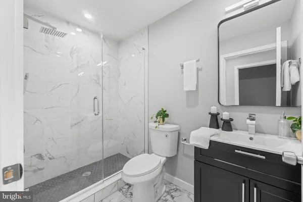 a bathroom with a sink toilet and shower