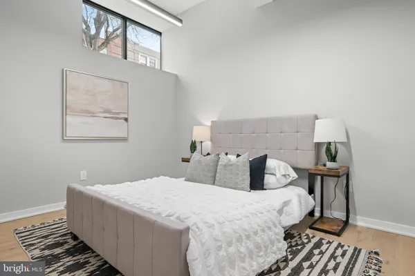 a bedroom with a bed and wooden floor