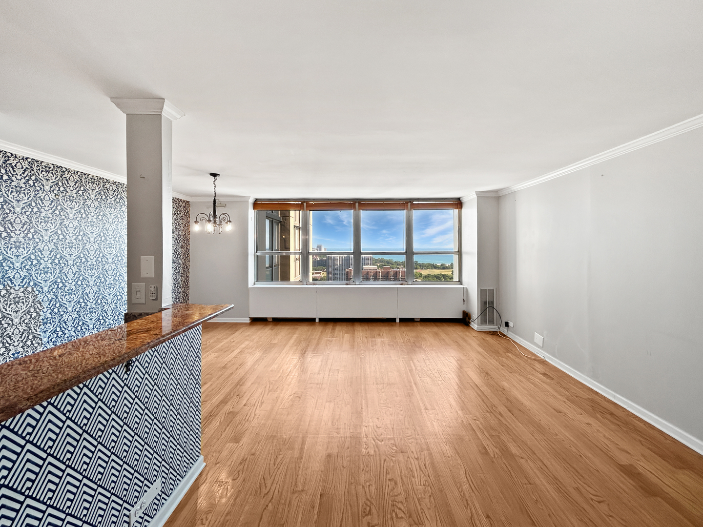 655 West Irving Park Road, Unit 3608 Chicago, IL 60613 - Photo 2 of 20 a view of a room with wooden floor and windows