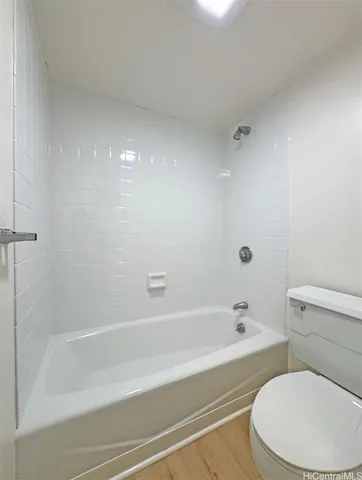 a white bath tub sitting next to a white toilet