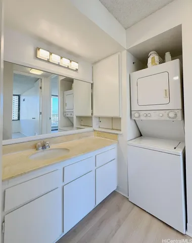 a bathroom with a sink and mirror with bathtub