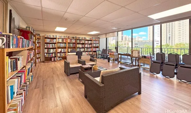 a living room with lots of furniture and a large window