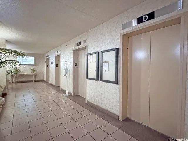 a view of a hallway to closet and livingroom