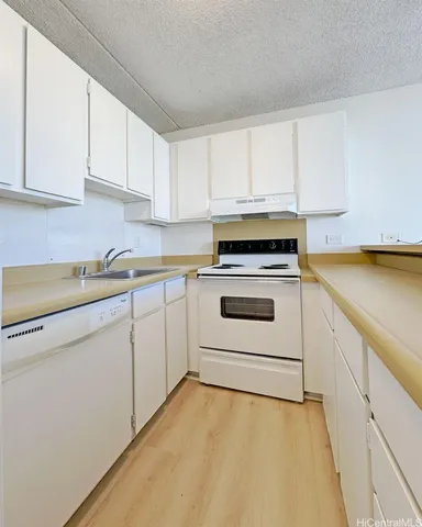 a kitchen with white cabinets and white appliances