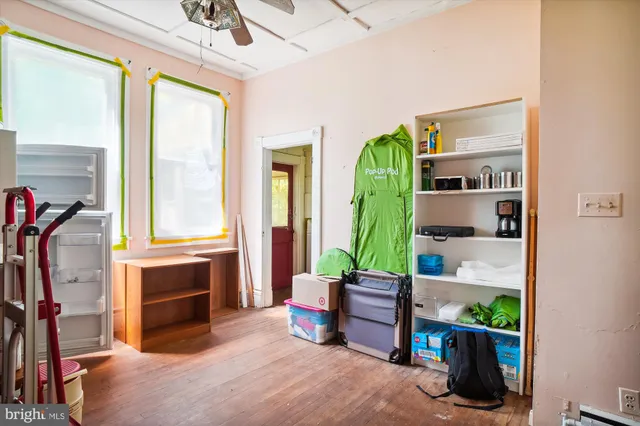 a living room with furniture a window and potted plants on the table
