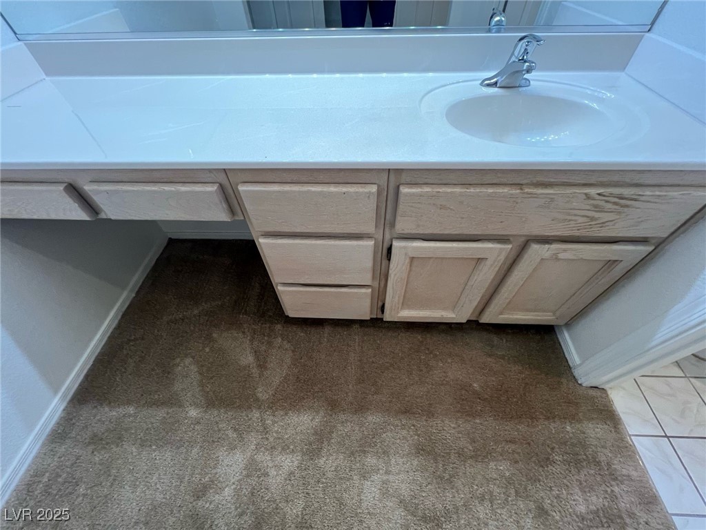 2306 Spring Water Drive Las Vegas, NV 89134 - Photo 16 of 24 Bathroom featuring vanity, dark colored carpet, and dark tile patterned floors