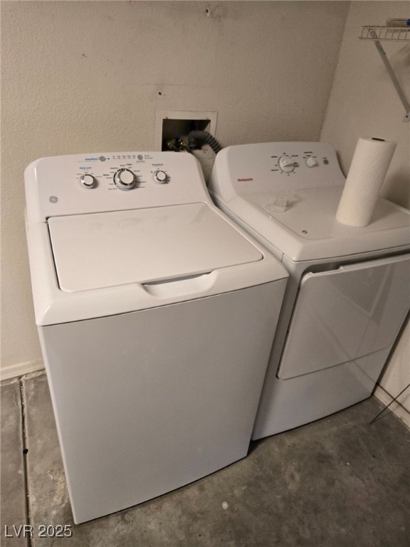 2306 Spring Water Drive Las Vegas, NV 89134 - Photo 22 of 24 Laundry area with washing machine and clothes dryer and a textured wall
