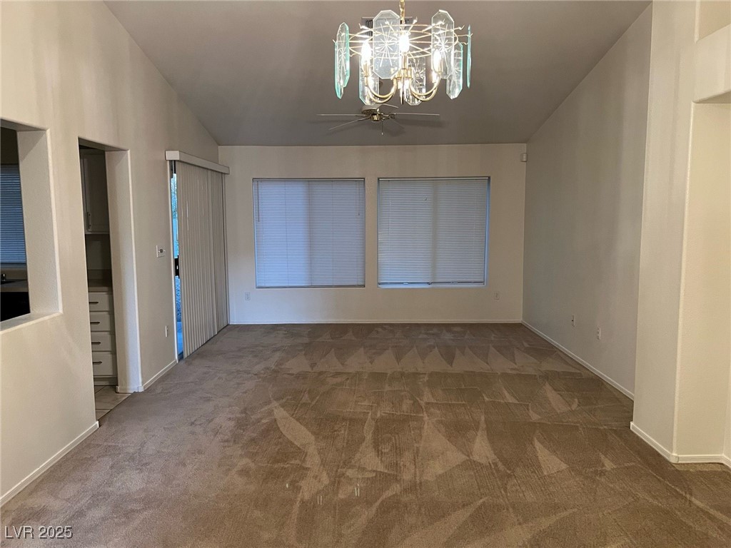 2306 Spring Water Drive Las Vegas, NV 89134 - Photo 10 of 24 Carpeted spare room with a chandelier and vaulted ceiling