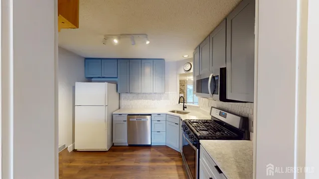 a view of a kitchen cabinets and wooden floor