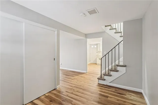 a view of a room with wooden floor and window
