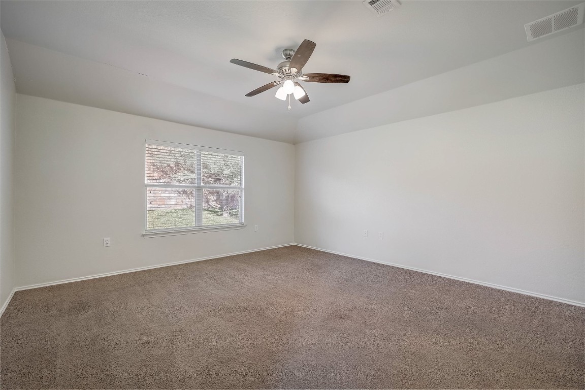 5800 Silver Screen Drive Austin, TX 78747 - Photo 17 of 31 an empty room with a window and a ceiling fan