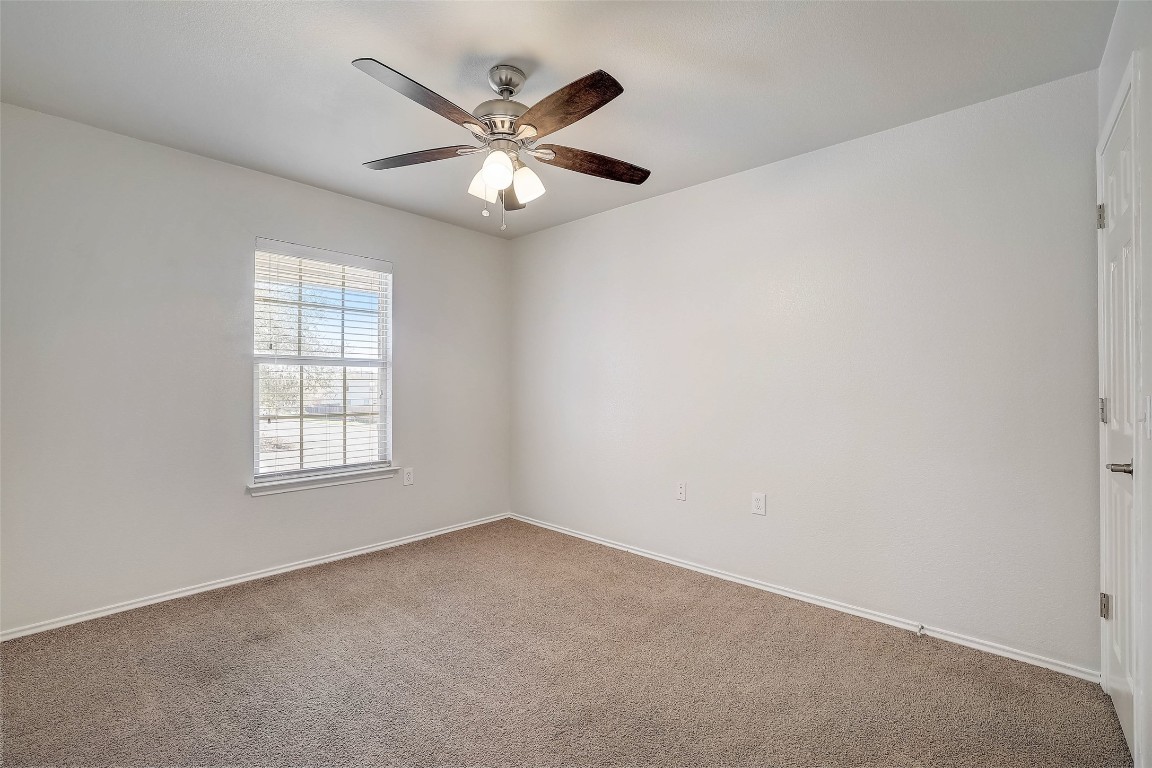 5800 Silver Screen Drive Austin, TX 78747 - Photo 24 of 31 an empty room with a window and a fan