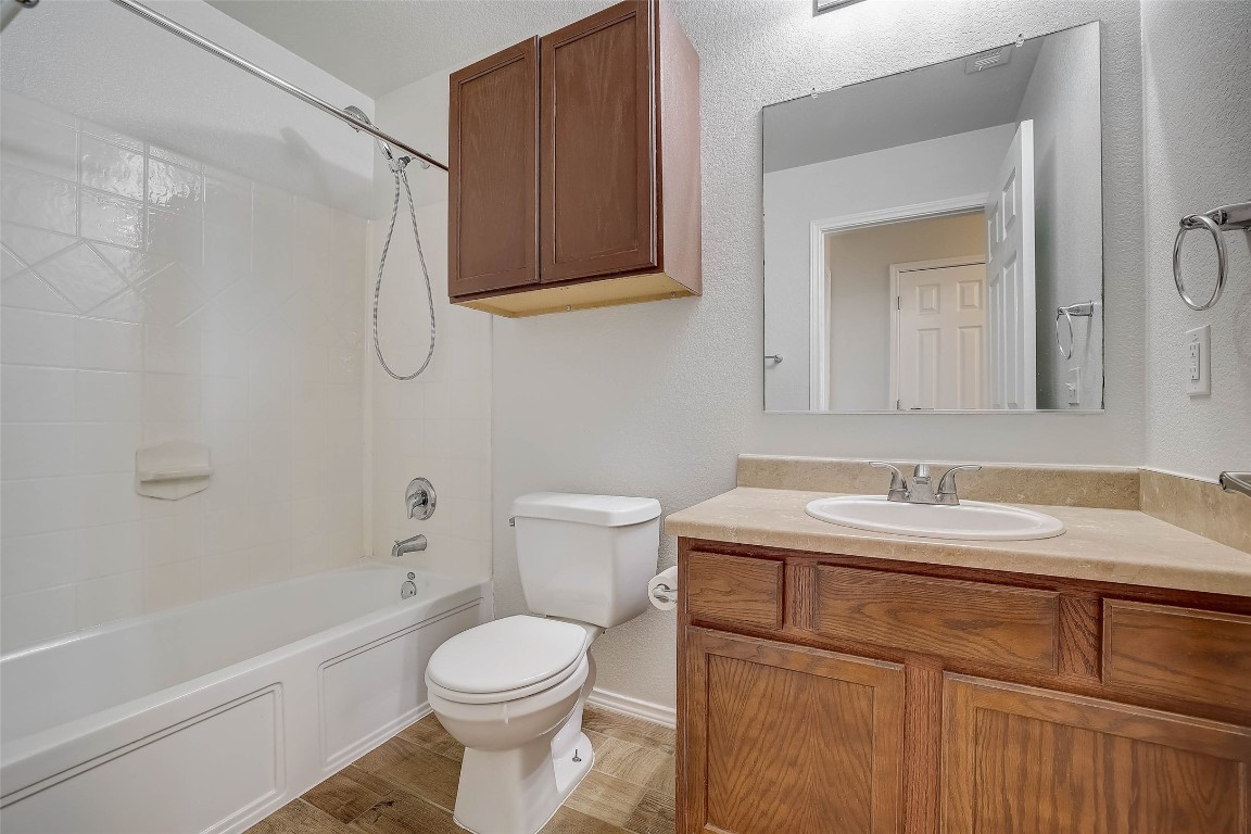 5800 Silver Screen Drive Austin, TX 78747 - Photo 25 of 31 a bathroom with a sink a toilet and shower