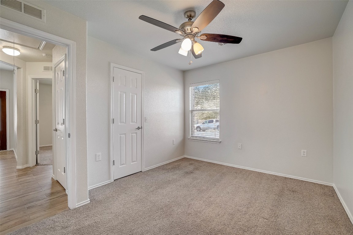 5800 Silver Screen Drive Austin, TX 78747 - Photo 26 of 31 an empty room with fan and windows