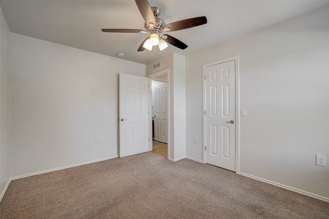 5800 Silver Screen Drive Austin, TX 78747 - Photo 27 of 31 an empty room with closet and a ceiling fan