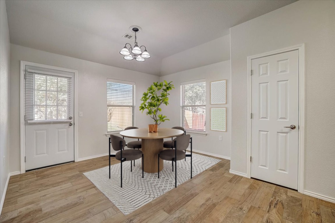 5800 Silver Screen Drive Austin, TX 78747 - Photo 3 of 31 a view of a dining room with furniture window and wooden floor