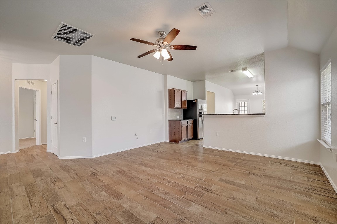 5800 Silver Screen Drive Austin, TX 78747 - Photo 7 of 31 a view of empty room with wooden floor and ceiling fan