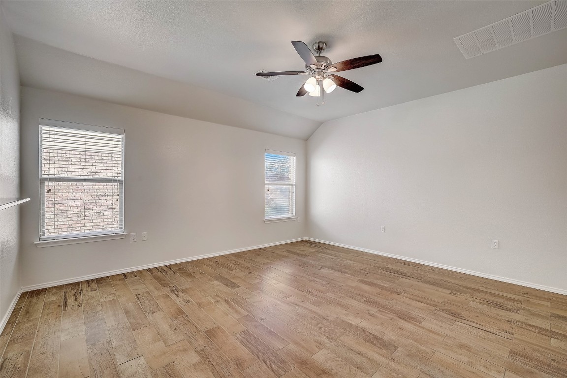 5800 Silver Screen Drive Austin, TX 78747 - Photo 9 of 31 a view of an empty room with wooden floor and a window