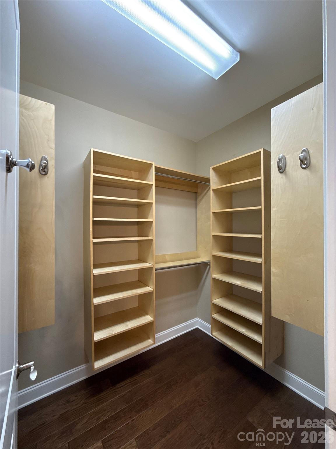 230 South Tryon Street, Unit 1002 Charlotte, NC 28202 - Photo 11 of 19 a view of walk in closet with empty racks